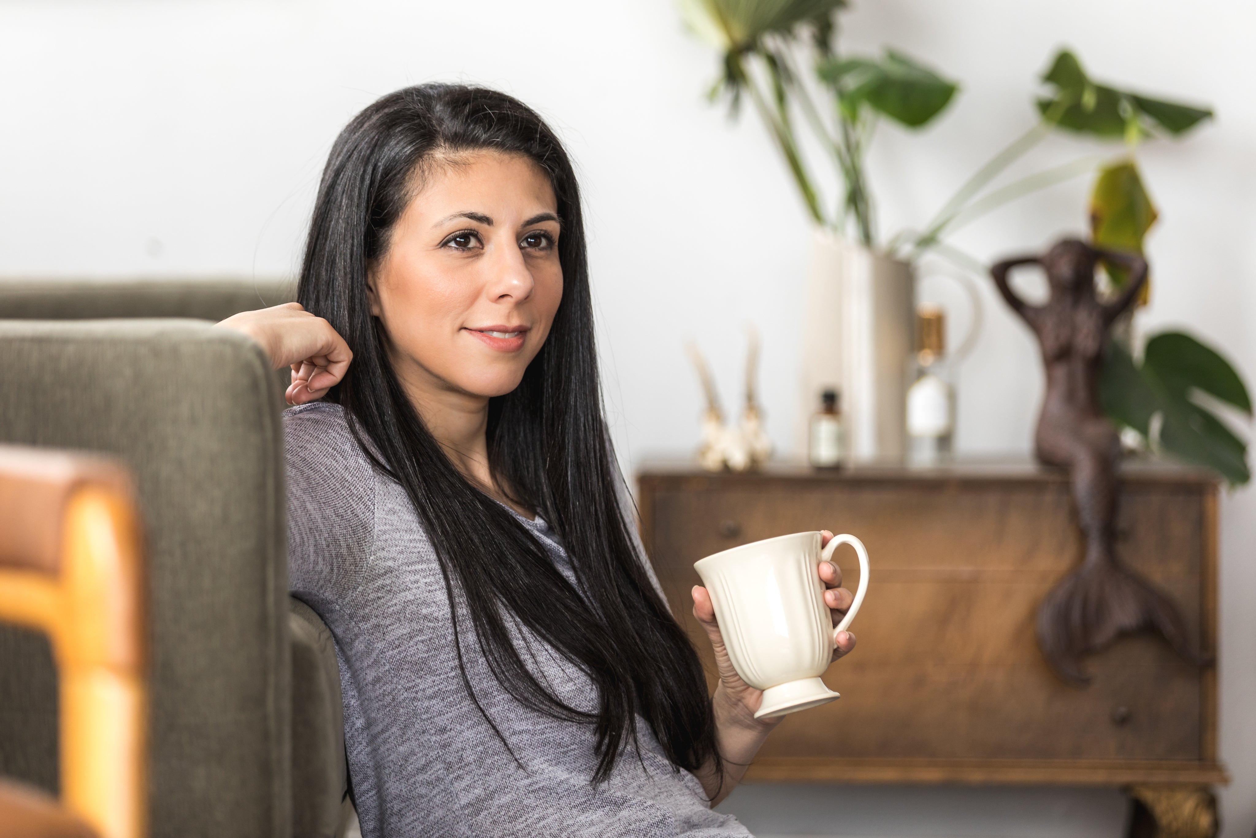 files/a-young-woman-leans-back-on-a-couch-with-a-coffee.jpg